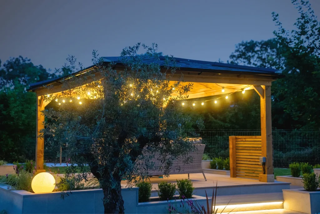 Illuminated timber gazebo creating a warm outdoor seating space in a Washingborough garden